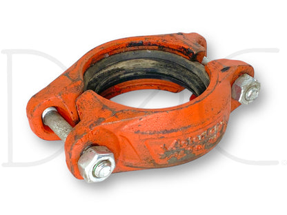 Victaulic 107N 3/88.9 Grooved Pipe Coupling Quickvic 3" used with light wear, orange cast steel body and tightened bolts, suitable for heavy-duty diesel truck pipe connections.