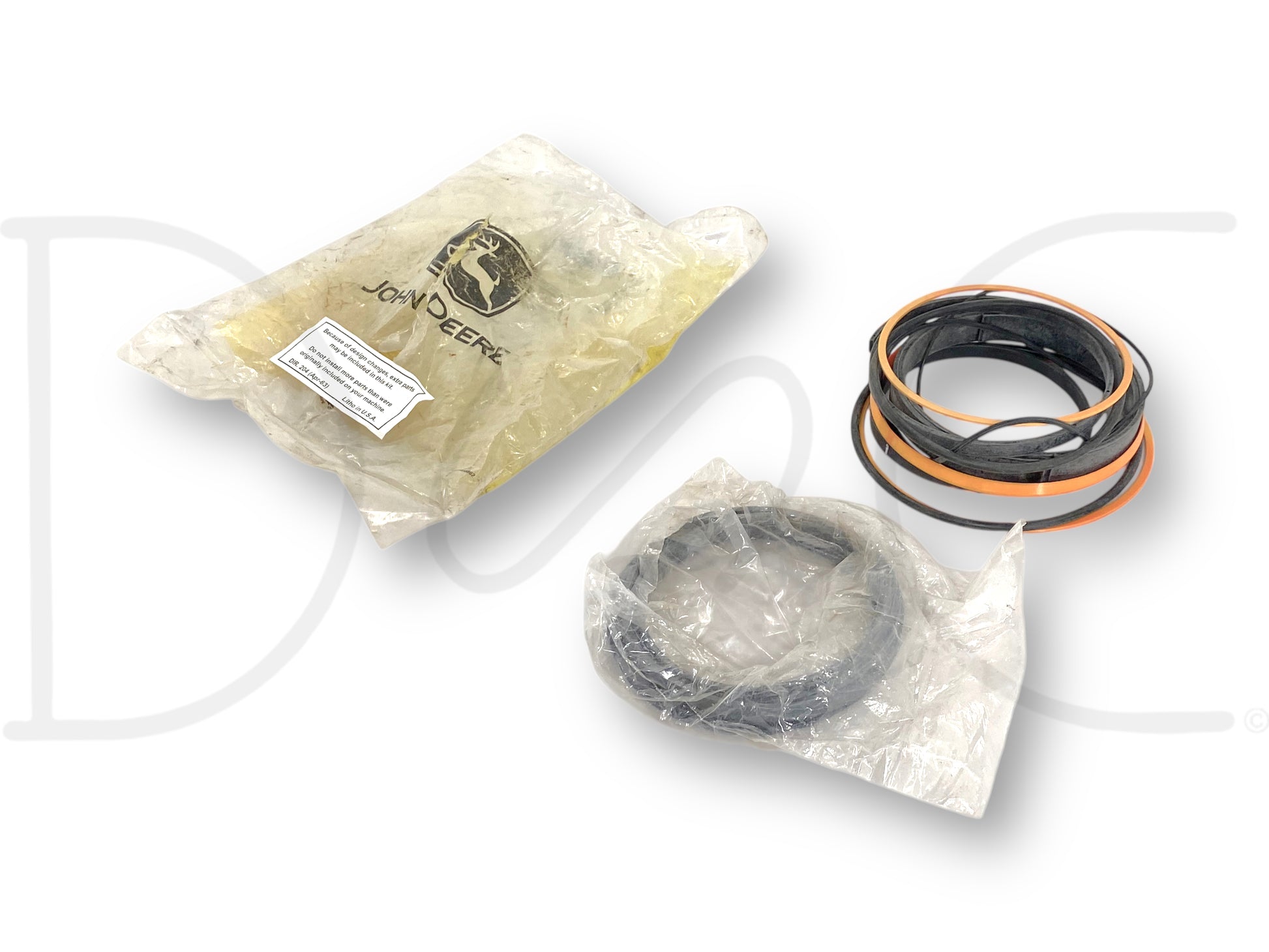 John Deere Ahc15497 Hydraulic Cylinder Bore Seal Kit OEM 14 Piece *Open Bag* showing a set of new old stock hydraulic seals in original packaging with some parts wrapped in plastic bags.