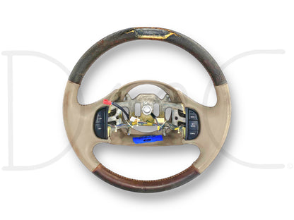 03-04 Ford F250 F350 King Ranch Steering Wheel W/ Cruise Tan Leather OE *Blem* used steering wheel with worn tan leather, cruise control buttons, and blemished top for Super Duty trucks.