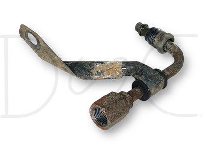 99-04 Ford F250 F350 RH Right Hydrboost Line Elbow Hose Adapter OEM with visible signs of light wear and rust, used component compatible with 6.0L Powerstroke engines in Ford F-250, F-350, F-450, and F-550 trucks from 1999 to 2004.