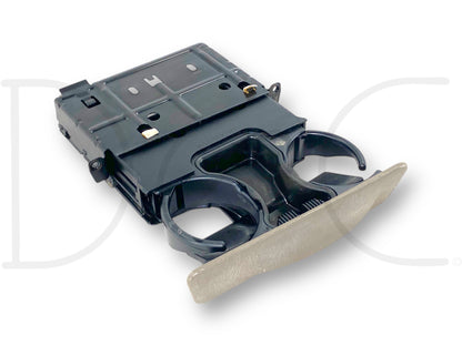 99-04 Ford F250 F350 Dash Cupholder Pull Out Assembly Tan OE *Blem* showing a used tan cupholder with light wear and blemishes, compatible with 1999-2004 Ford F-250, F-350, F-450, and F-550 Super Duty trucks, suitable for models with 6.0L diesel engines.