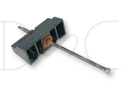 99-10 Ford F250 F350 Super Duty Battery Retainer Hold Down Bracket OEM used condition showing light wear, black plastic bracket with attached metal rod and rusty screw, compatible with 7.3L Powerstroke diesel Ford trucks from 1999 to 2010.