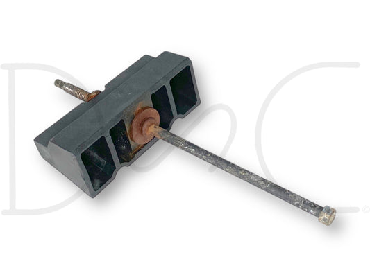 99-10 Ford F250 F350 Super Duty Battery Retainer Hold Down Bracket OEM used condition showing light wear, black plastic bracket with attached metal rod and rusty screw, compatible with 7.3L Powerstroke diesel Ford trucks from 1999 to 2010.