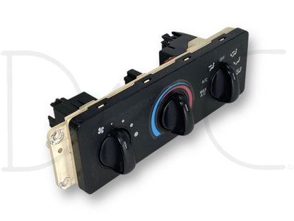 99-04 Ford F250 F350 HVAC Heater A/C Temp Climate Control Switch Panel *Blem* showing black control knobs on a rectangular panel with fan speed, temperature, and vent mode settings, used part with light wear and minor crack near illumination bulb housing.