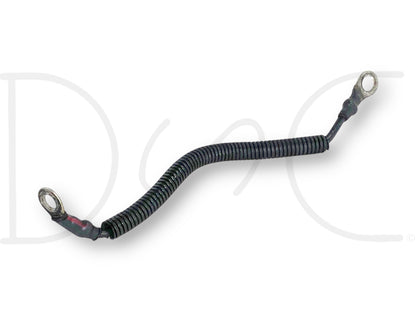 99-02 Ford F250 F350 7.3 7.3L Diesel AIH Air Intake Heater Ground Wire Cable OE used part with light wear, featuring a coiled black protective covering and metal ring terminals on both ends for secure connection in diesel engine systems.