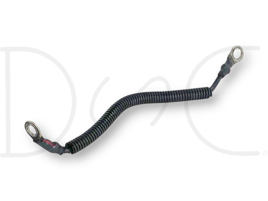 99-02 Ford F250 F350 7.3 7.3L Diesel AIH Air Intake Heater Ground Wire Cable OE used part with light wear, featuring a coiled black protective covering and metal ring terminals on both ends for secure connection in diesel engine systems.