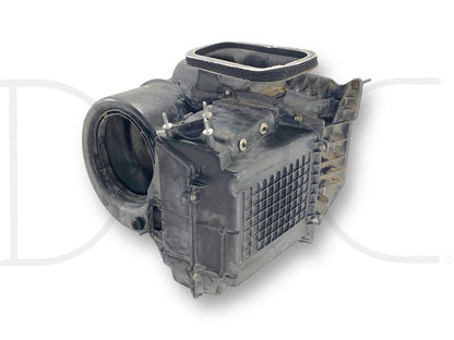 Used black plastic 99-02 Ford F250 F350 HVAC Exterior Under Hood Air Box Blower Motor Housing OEM with light wear, compatible with Ford Super Duty trucks including F-250, F-350, F-450, and F-550 models from 1999 to 2004.