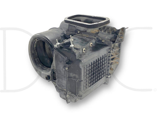 Used black plastic 99-02 Ford F250 F350 HVAC Exterior Under Hood Air Box Blower Motor Housing OEM with light wear, compatible with Ford Super Duty trucks including F-250, F-350, F-450, and F-550 models from 1999 to 2004.