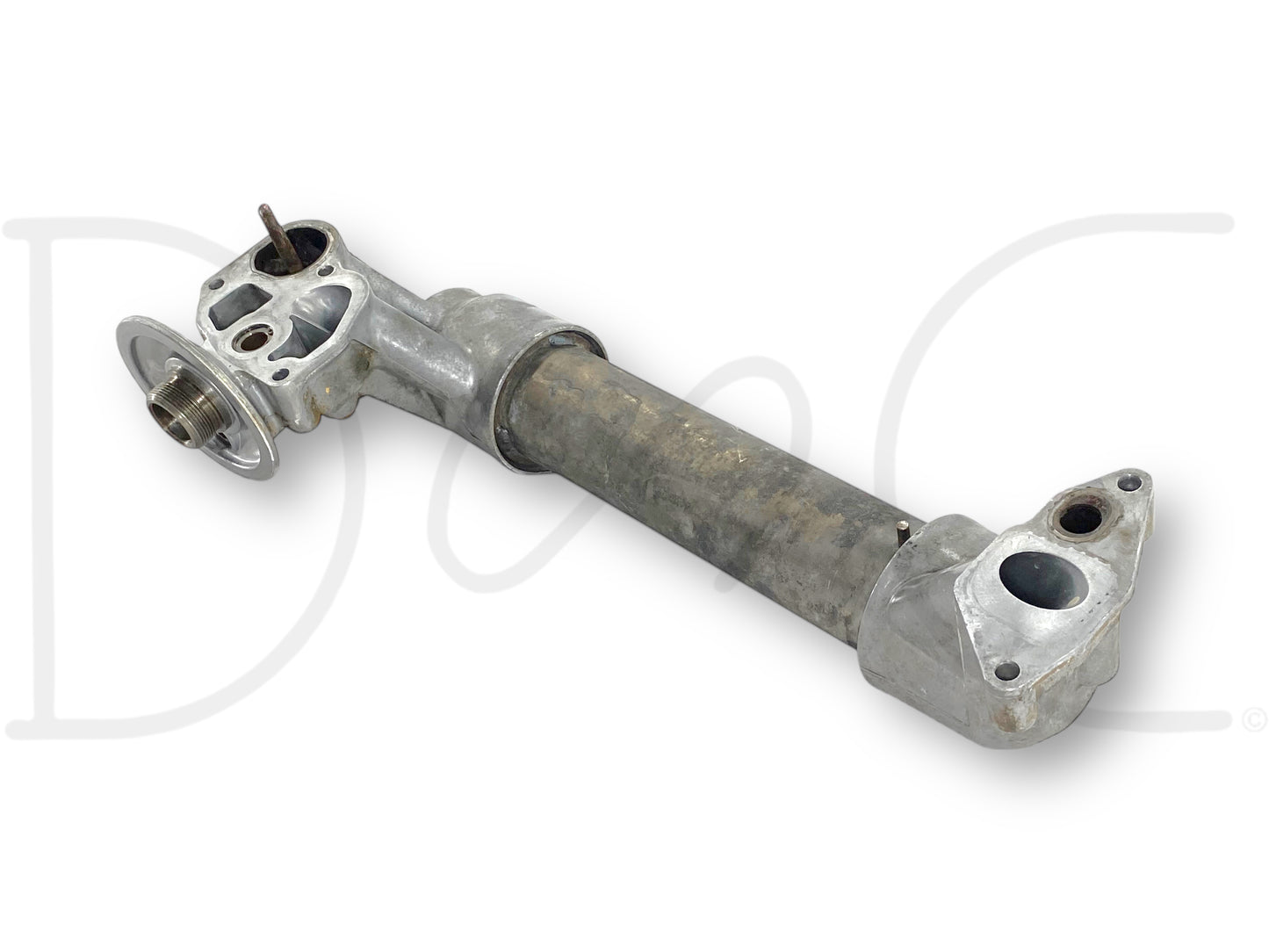 Used metal oil cooler assembly with aftermarket tube and OEM caps, showing light wear and suitable for diesel engine cooling, specifically the 99-02 Ford F250 F350 7.3 7.3L Powerstroke Diesel Oil Cooler Assembly 1815739C2.