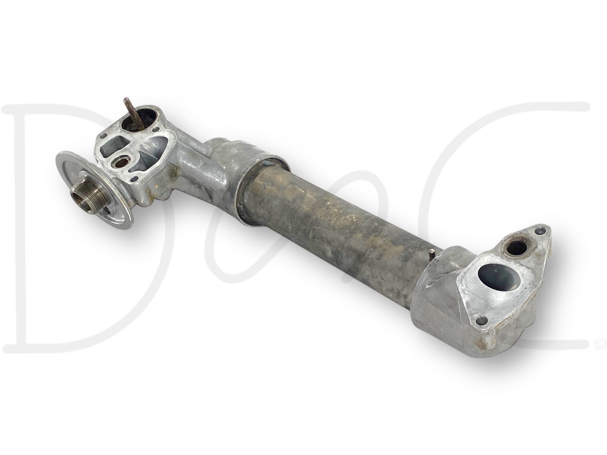Used metal oil cooler assembly with aftermarket tube and OEM caps, showing light wear and suitable for diesel engine cooling, specifically the 99-02 Ford F250 F350 7.3 7.3L Powerstroke Diesel Oil Cooler Assembly 1815739C2.
