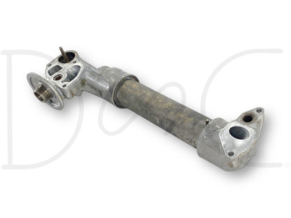 Used metal oil cooler assembly with aftermarket tube and OEM caps, showing light wear and suitable for diesel engine cooling, specifically the 99-02 Ford F250 F350 7.3 7.3L Powerstroke Diesel Oil Cooler Assembly 1815739C2.