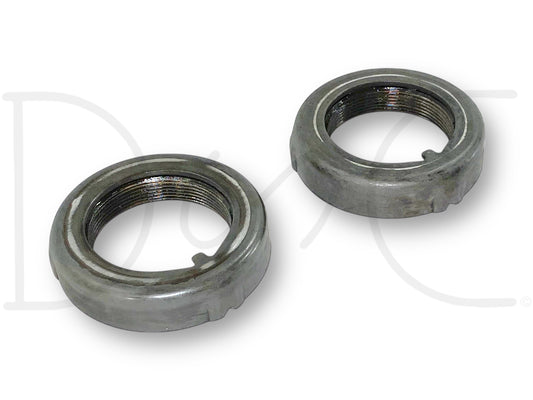 Two used metal retainer nuts with threaded interiors, showing light wear, for the 99-04 Ford F250 F350 Sterling 10.5 Rear Axle Wheel Hub Bearing Retainer Nut Set, suitable for Ford Super Duty trucks with 7.3L diesel engines and 4R100 automatic transmissions.