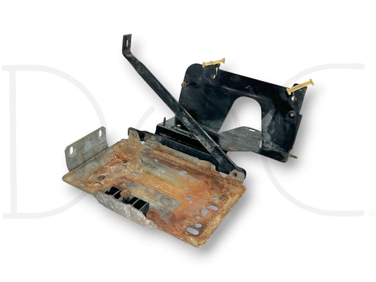 94-97 Ford F250 F350 Diesel RH Right Passenger Side Battery Tray Mount Bracket used with light wear, featuring rust on metal base and black bracket components.