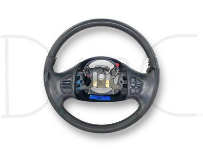 05-07 Ford F250 F350 Black Leather Steering Wheel W/ Stereo Temp Cruise *Blem* showing a used, blemished condition with leather wrap missing on the top half and heavily worn surface, buttons also worn and damaged, compatible with 2005-2007 Ford Super Duty trucks.