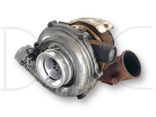 06-07 Ford F250 F350 6.0 6.0L Diesel Turbo Turbocharger Garrett OE *Core* showing used turbocharger unit with visible turbine blades and rusted exhaust housing, fitting 2006-2007 Ford Super Duty 6.0 Powerstroke engines, sold as-is for parts or rebuild.